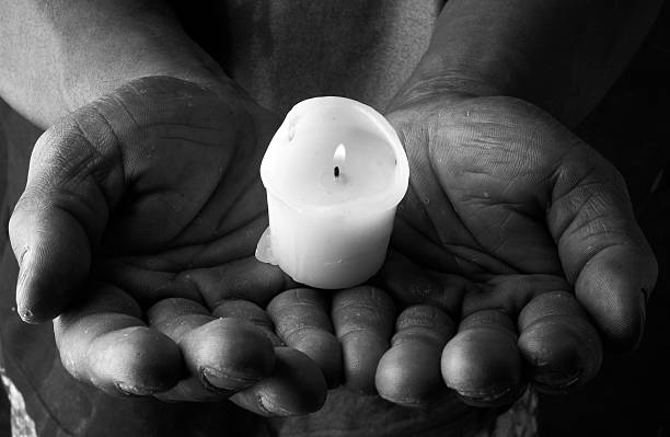 Candle in Hands stock photo