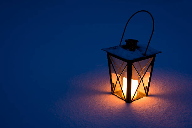 Candle Lantern in Snow stock photo