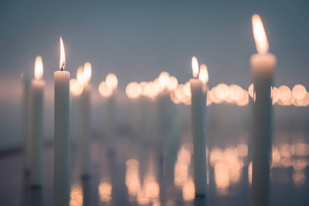 Candle Memorial Low Angle A low angle image of a huge group of wax candles all lit up with selective foreground focus Cape Town South Africa memorial event stock pictures, royalty-free photos & images