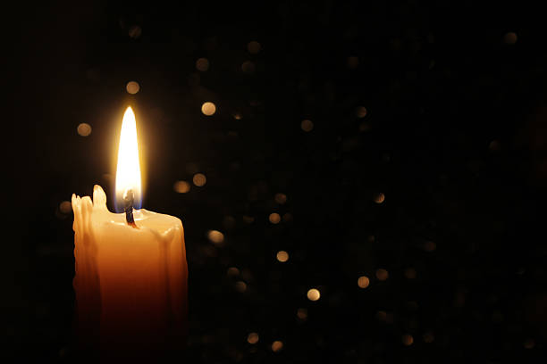 Candles Burning at Night White Candles Burning in the Dark with focus on single candle in foreground. candle stock pictures, royalty-free photos & images