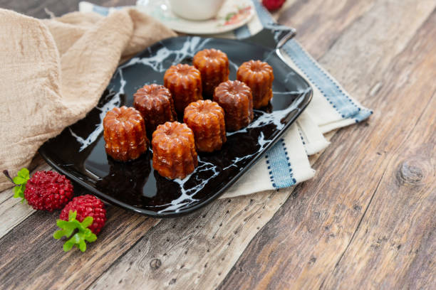 Canele is a small French pastry with rum and vanilla Canele is a small French pastry with rum and vanilla bordeaux photos stock pictures, royalty-free photos & images