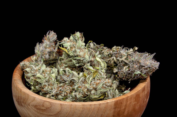 Cannabis buds in wooden bowl stock photo