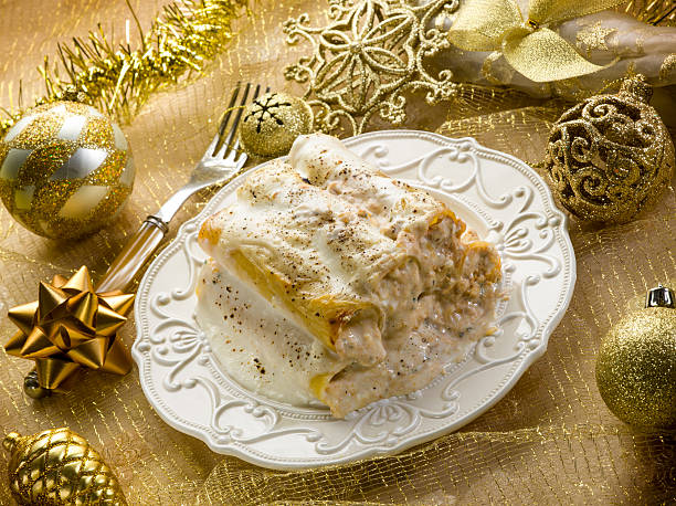 cannelloni over golden christmas table stock photo
