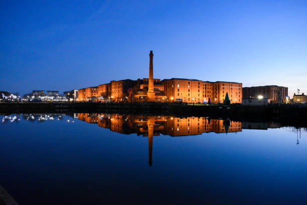 Canning Dock Liverpool Night time photo of the Pump House in Canning Dock in Liverpool, with a light show in the corner. liverpool england photos stock pictures, royalty-free photos & images