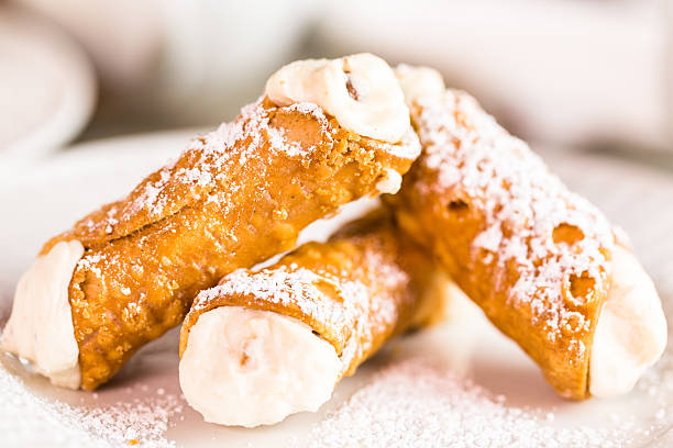 Cannoli Fresh Italian cannoli with coffee on the table. cannoli stock pictures, royalty-free photos & images