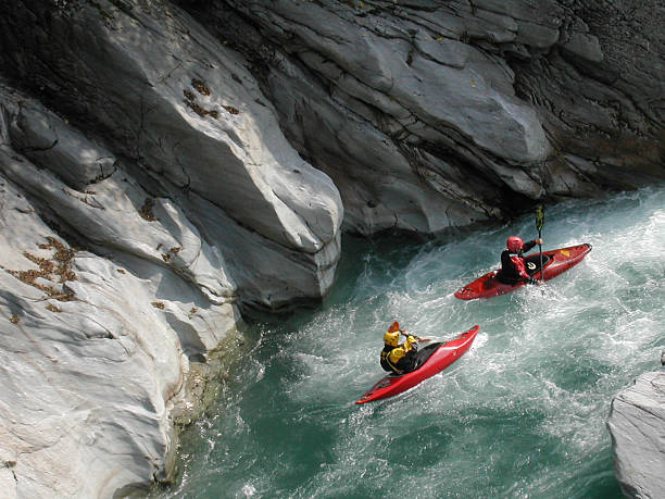 canoeist down the Sesia river "two canoeist down the Sesia river, in italy.Extreme sports:" rapids river stock pictures, royalty-free photos & images