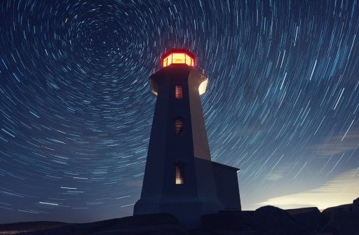 Peggy's Cove Lighthouse under a canopy of spinning stars.  Long exposure.
