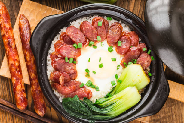 Cantonese style cooking of claypot rice with waxed meats stock photo