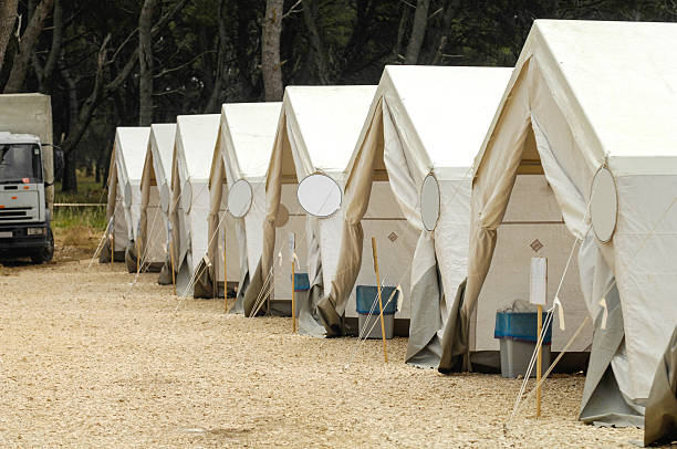 Canvas pole tents in a row ready for action stock photo