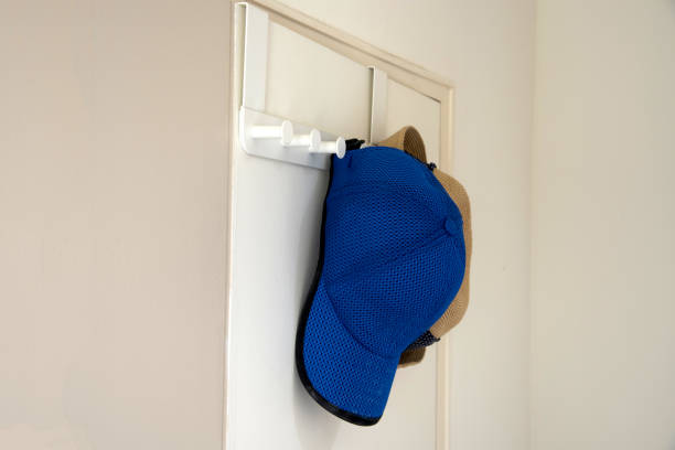 Cap and hat hang on wall stock photo