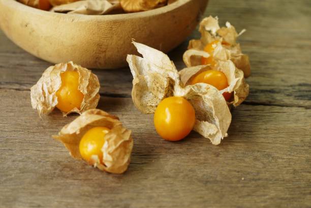 Cape Gooseberry on wooden floor texture with copy space  use for backgroud or wallpaper , selective  focus . stock photo