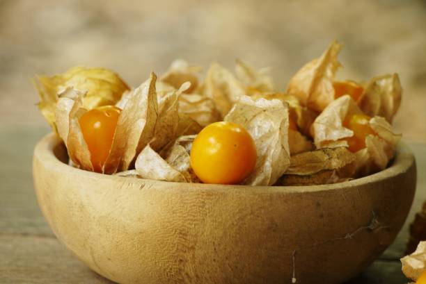 Cape Gooseberry on wooden floor texture with copy space  use for backgroud or wallpaper , selective  focus . stock photo