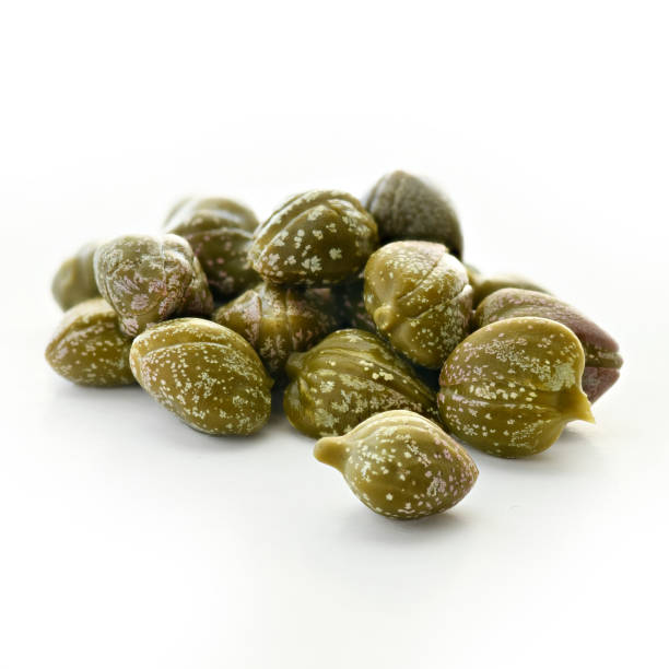 capers isolated capers on a isolated white background, square format, selective focus caper stock pictures, royalty-free photos & images