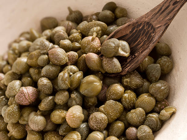 capers close up of a bowl of capers caper stock pictures, royalty-free photos & images