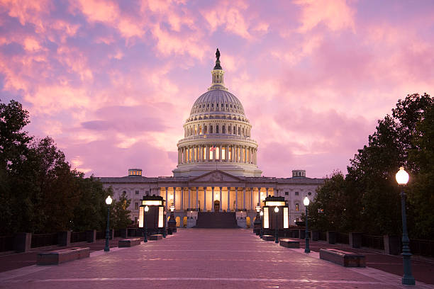 Capitol Building Sunset - Washington DC Washington DC: The sun sets on the United States Capitol building. architectural dome stock pictures, royalty-free photos & images