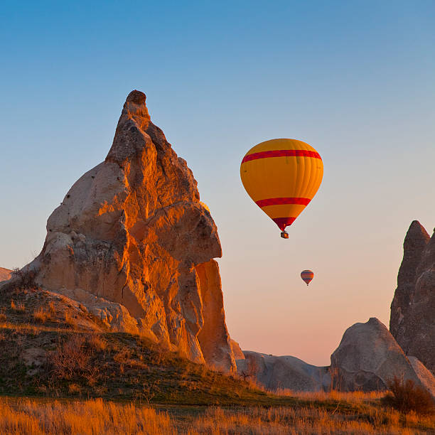 Cappadocia, Turkey Hot Air Balloons rise up over the Goreme Valley in Cappadocia, Turkey turkey country stock pictures, royalty-free photos & images