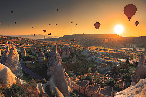 Cappadocia valley at sunrise Hot air balloon flying over spectacular Cappadocia rock hoodoo stock pictures, royalty-free photos & images