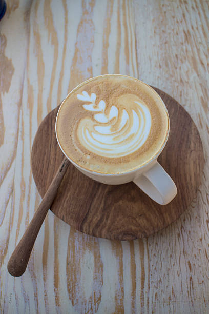 Cappuccino on wooden table stock photo