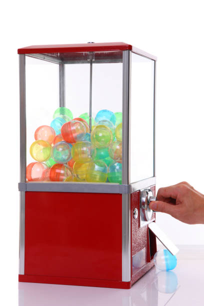 capsule toy vending machine with hand turn a lever studio shot of capsule toy vending machine called GASHAPON or GACHAGACHA with hand turn a lever on white background  Gacha stock pictures, royalty-free photos & images