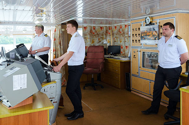 Captain of ship Alexander Benois and mates in captain's cabin stock photo