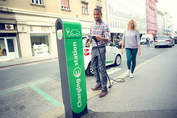 car charging station - electric car woman bildbanksfoton och bilder