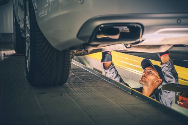 Car Diagnostic Technician Car Diagnostic Technician Under the Vehicle. Automotive Industry. auto mechanic stock pictures, royalty-free photos & images