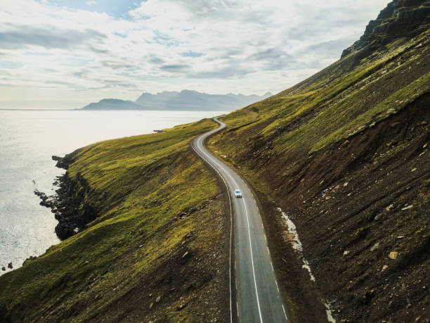 Car driving on beautiful scenic road in Iceland. car driving on beautiful road, travel background, aerial scenic landscape from Iceland wilderness stock pictures, royalty-free photos & images