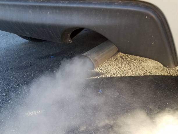 car exhaust or smoke and black asphalt stock photo