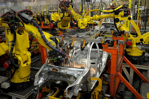 Car factory building new vehicles with robotic arms stock photo