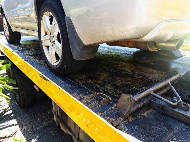 Car loaded onto tow truck showing fastening mechanism Cropped look at part of a car loaded onto a tow truck and being anchored to it for safety. anchor point stock pictures, royalty-free photos & images