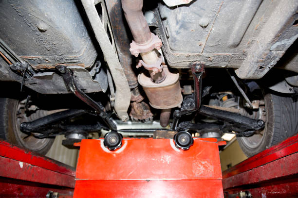Car on lift in the auto shop Car on lift in the auto shop plug adapter stock pictures, royalty-free photos & images