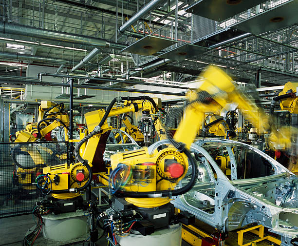 car production line yellow robots welding cars in a production line car plant stock pictures, royalty-free photos & images
