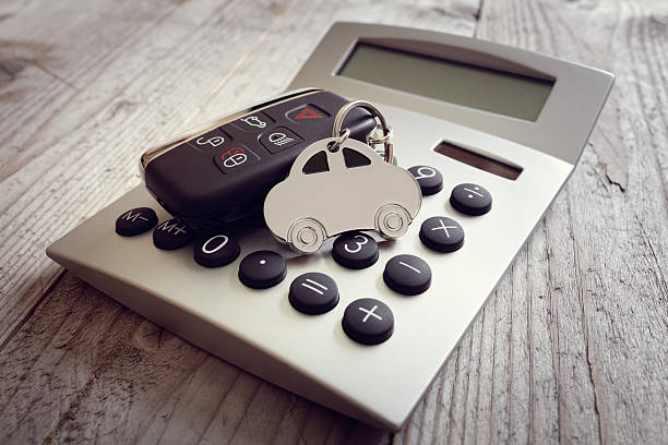 car shape keyring and key on calculator - car financing bildbanksfoton och bilder