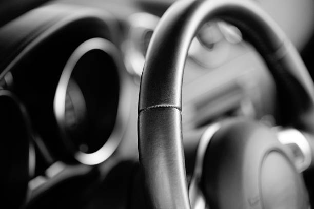 Car steering wheel (trough the windshield)  luxury car stock pictures, royalty-free photos & images