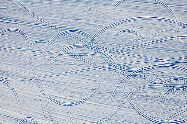 Car tracks in the snow stock photo