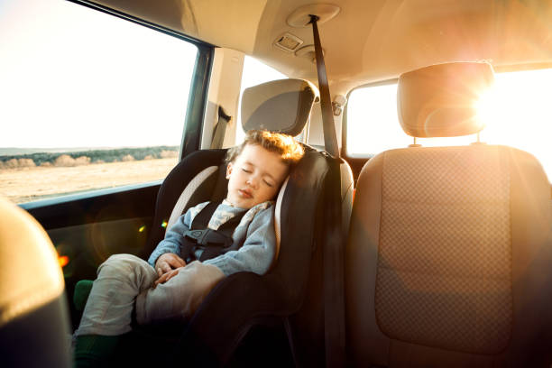 Car Trip Smiling little boy sitting car in child seat car safety seat stock pictures, royalty-free photos & images