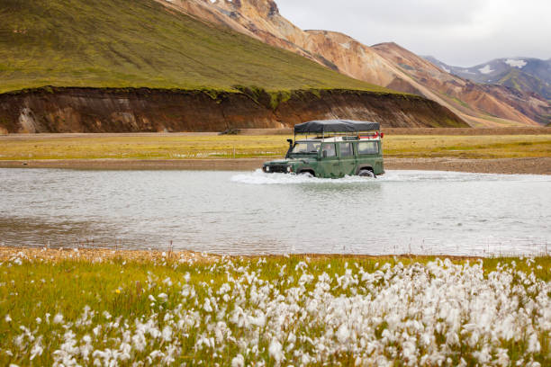 4WD car wades river, Iceland stock photo