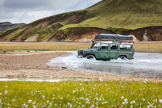 4WD car wades river in Landmannalaugar, Iceland stock photo