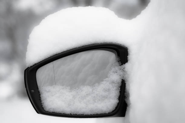 car wing mirror close up, snowcapped in black and white stock photo