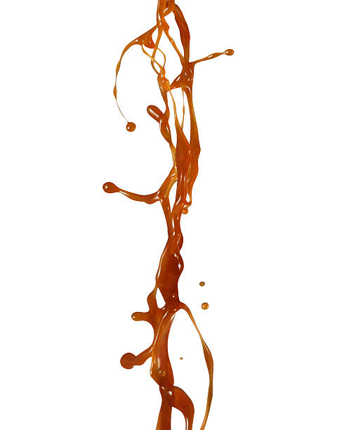 Caramel syrup splashing Caramel syrup splashing isolated on white background sauce stock pictures, royalty-free photos & images