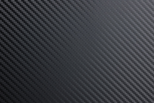 detailed tightly woven carbon fibre background texture.