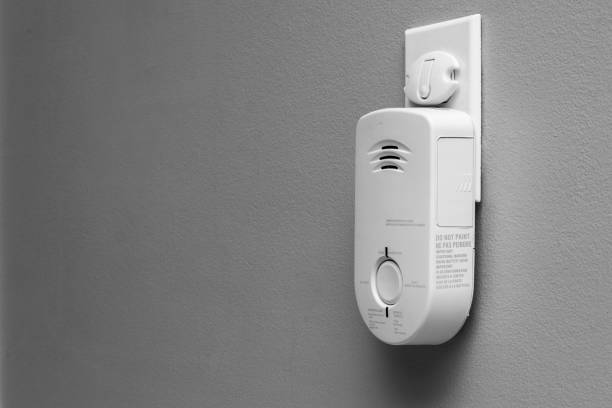 Carbon Monoxide (CO) monitor plugged into the wall of a residential house for safety. stock photo