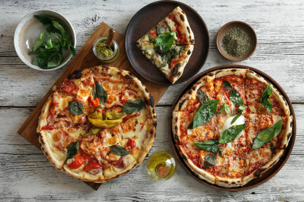 carbonara pizza and meat pizza - pizza table imagens e fotografias de stock