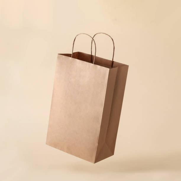 Cardboard brown levitation paper bag for shop shopping and business mockup. stock photo