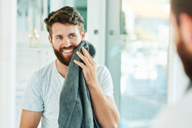 Care for your beard and you won't regret it Cropped shot of a young man drying his beard with a towel beard stock pictures, royalty-free photos & images