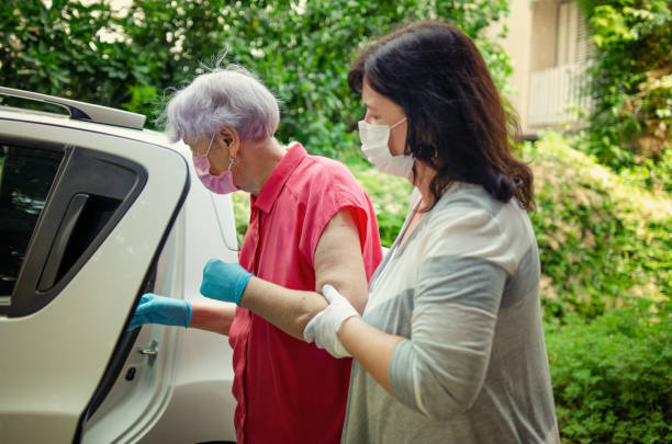 Caregiver escorting her elderly client to medical or other appointments. stock photo