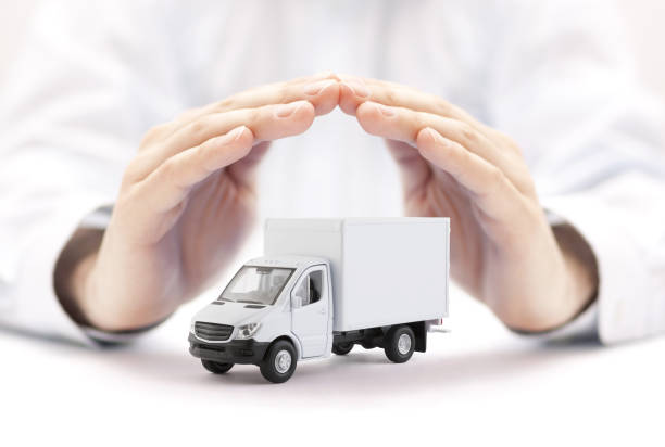 Cargo delivery truck protected by hands stock photo