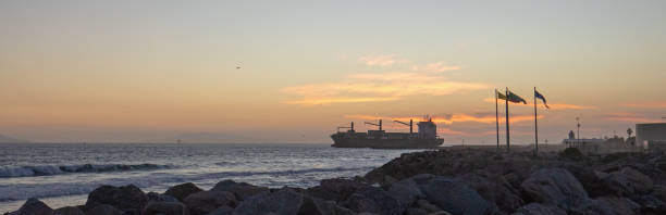 Cargo Freight Ship at sunset at Port Hueneme port channel in Oxnard California United States stock photo
