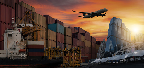 Cargo planes flying over container berths and berths. It is used for transportation and freight logistics industry in the capital city.