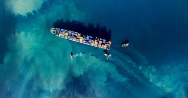 cargo ship Aerial shoot of a cargo ship mooring in a harbour container ship stock pictures, royalty-free photos & images
